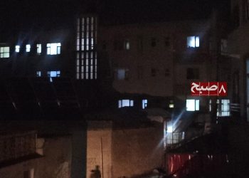 Buildings stand partially lit at night in Kabul as prolonged power outages continue amid a summer surge in seasonal illnesses. (Photo credit: 8am.media)