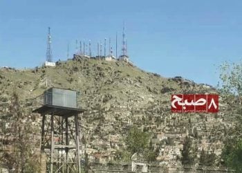 Telecommunication towers stand on a hilltop overlooking a residential neighborhood in Kabul, where residents complain of costly and low-quality internet services. (Photo credit: 8am.media)