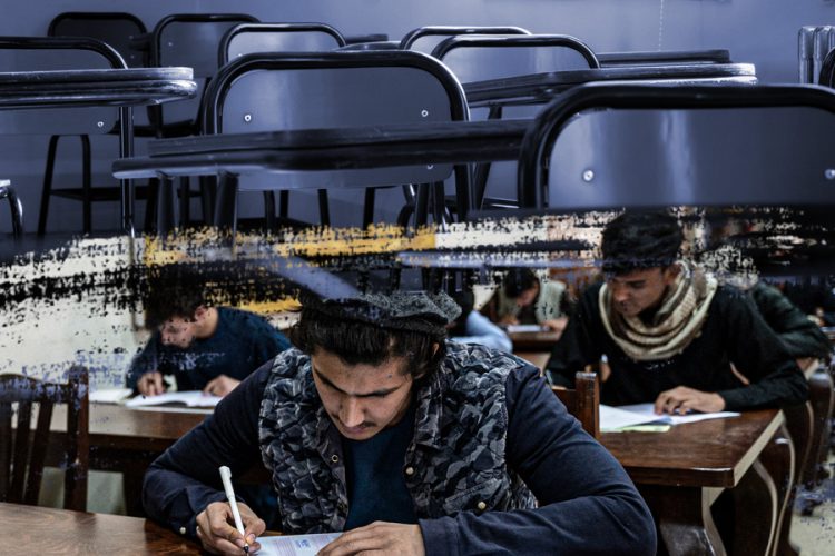 Male candidates sit for the Kankor university entrance exam in a classroom, as girls remain barred from taking part under Taliban restrictions. (Photo credit: AFP)