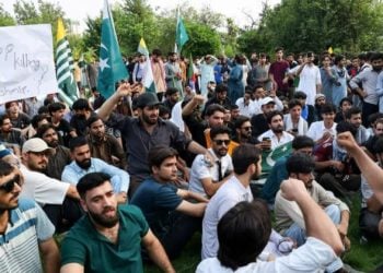 Demonstrators hold flags and placards during a public protest in support of Kashmir (Photo: Reuters)