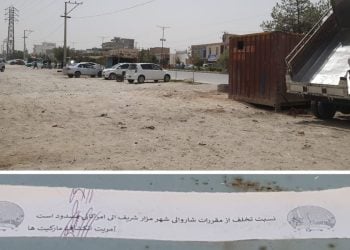 A municipal warning notice is pasted on a container along a roadside in Mazar-e-Sharif, where stall owners say the Taliban have ordered them to pay or clear out. (Photo credit: Exclusive)