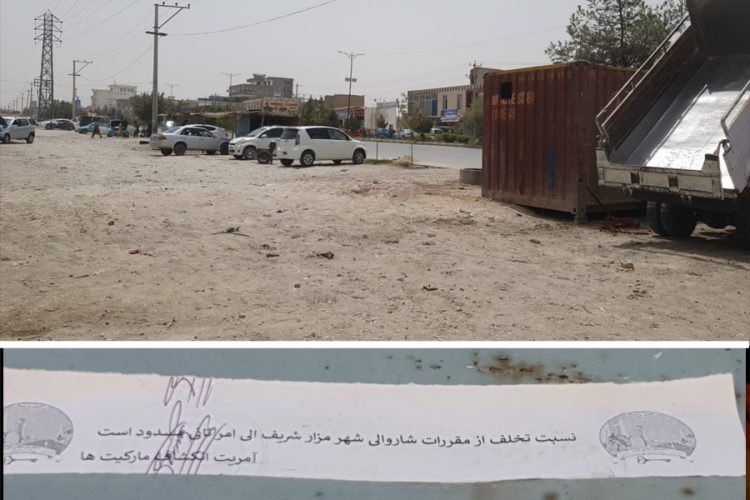 A municipal warning notice is pasted on a container along a roadside in Mazar-e-Sharif, where stall owners say the Taliban have ordered them to pay or clear out. (Photo credit: Exclusive)