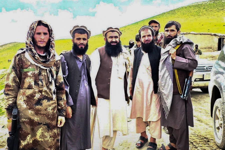 Armed Taliban members pose together outdoors in Badakhshan province. (Photo credit: Exclusive)