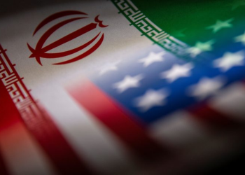 A blended image of the Iranian and US flags represents rising tensions over control and security of the Strait of Hormuz. (Photo credit: Reuters)
