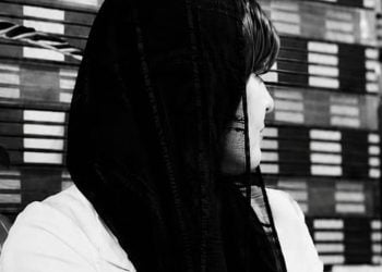 A black-and-white portrait captures a moment of quiet contemplation, symbolizing the experiences and resilience of women facing adversity (Photo: Exclusive)