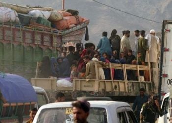 Afghan refugees travel with their belongings in vehicles near what appears to be a border crossing (Photo: UNHCR)