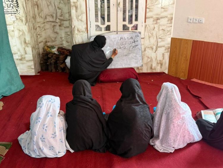 Girls attend a class taught by a woman as many girls in Afghanistan remain denied access to education. (Photo credit: OCHA)