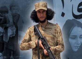 A camouflage-clad fighter poses with a rifle against a mural backdrop layered with images of displaced children and a grieving woman, symbolizing the human cost of conflict in Afghanistan. (Photo credit: AFP + Pexels)