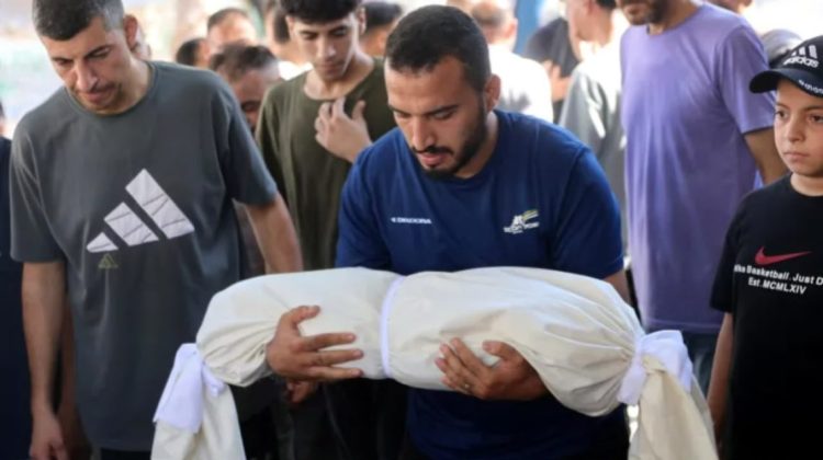 A person holds an image of a victim as Palestinians mourn amid ongoing Israeli attacks and rising casualties in Gaza. (Photo credit: AFP)