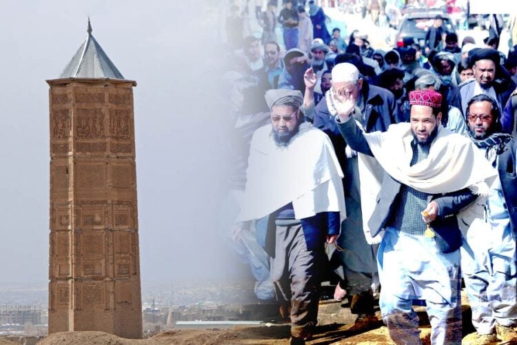 Religious and community leaders march through Ghazni, with the city's historic minaret rising in the background, amid protests over Taliban eviction orders. (Photo credit: AFP)