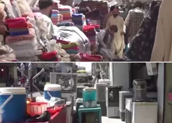 Shopkeepers' goods and vendors' carts crowd a sidewalk in Herat, leaving pedestrians little room to pass. (Photo credit: Exclusive)