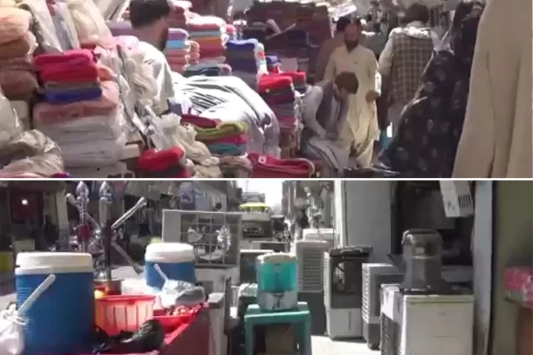 Shopkeepers' goods and vendors' carts crowd a sidewalk in Herat, leaving pedestrians little room to pass. (Photo credit: Exclusive)