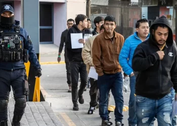 ICE officers detain immigrants during an enforcement operation, as individuals are escorted away under the supervision of law enforcement (Photo: Getty Images)