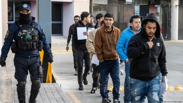 ICE officers detain immigrants during an enforcement operation, as individuals are escorted away under the supervision of law enforcement (Photo: Getty Images)