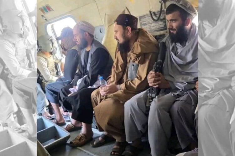 Juma Khan Fateh sits aboard a Taliban helicopter alongside armed fighters as he is transferred to Faizabad after surrendering. (Photo credit: Exclusive)