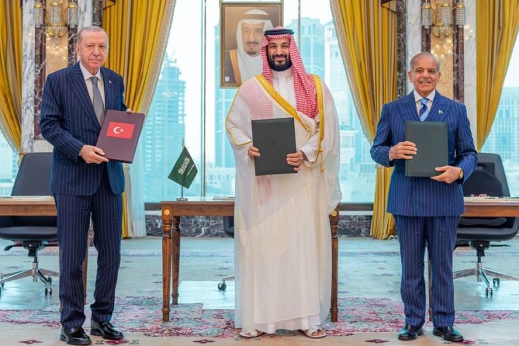 Turkish President Recep Tayyip Erdogan, Saudi Crown Prince Mohammed bin Salman, and Pakistani Prime Minister Shehbaz Sharif pose together after signing the Mecca Pact defense agreement. (Photo credit: Reuters)