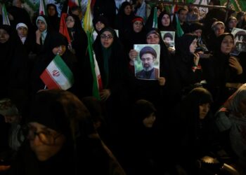 Women gather during a demonstration in Iran while holding images of Mojtaba Khamenei. (Photo credit: REUTERS)