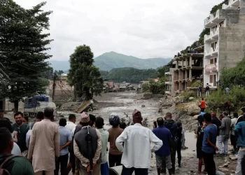 Caption: A crowd of people gathers in Nepal following devastating floods that have caused widespread destruction and casualties. (Photo credit: Reuters)