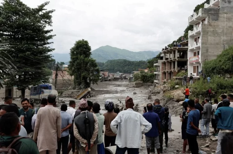 Caption: A crowd of people gathers in Nepal following devastating floods that have caused widespread destruction and casualties. (Photo credit: Reuters)