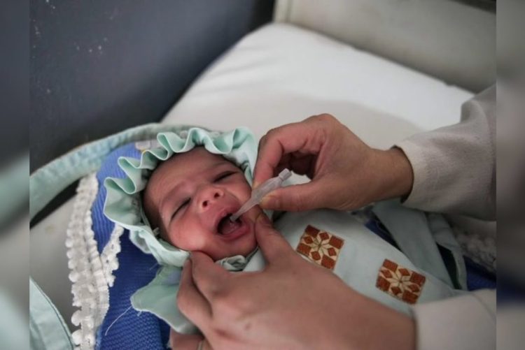 A child receives oral polio vaccine during a vaccination campaign in Afghanistan. (Photo credit: @PolioFreeAfghan)