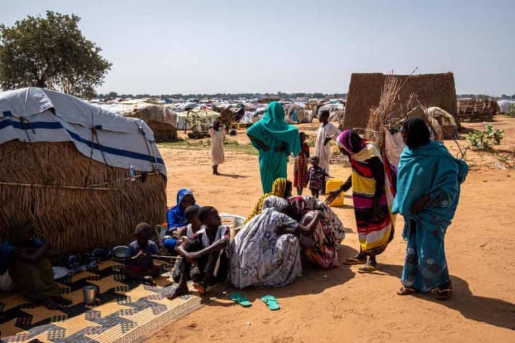 People gather in a village in South Sudan amid a worsening hunger crisis affecting millions across the country. (Photo credit: Guardian)