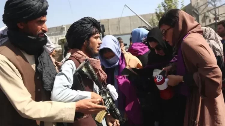 Taliban armed fighters stop and check people at a checkpoint in Afghanistan. (Photo credit: GETTY IMAGES)