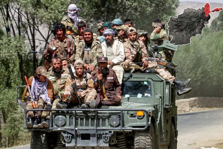 Armed Taliban fighters ride atop a military Humvee in Afghanistan, as clashes erupt with a dissident commander's forces in Badakhshan's Nusay district. (Photo credit: AFP)