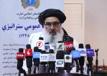 Taliban’s health minister speaks at a podium during the announcement of a five-year programme aimed at reducing maternal and child deaths in Afghanistan. (Photo credit: moph.gov.af)