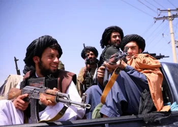 Taliban armed militants sit on a vehicle after the group captured Zaranj city, the first provincial capital seized during their 2021 offensive. (Photo credit: Reuters)