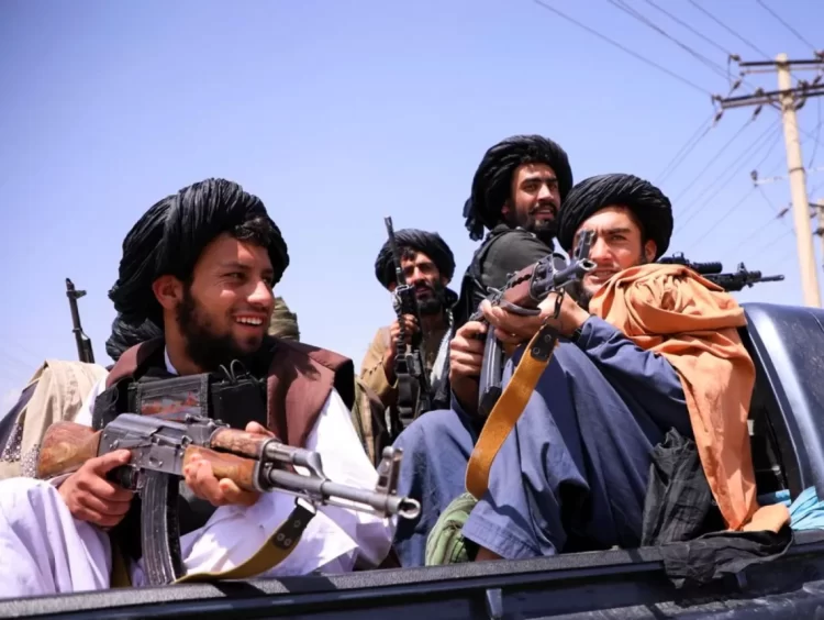Taliban armed militants sit on a vehicle after the group captured Zaranj city, the first provincial capital seized during their 2021 offensive. (Photo credit: Reuters)