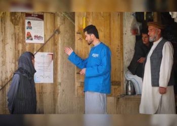 WHO employees explain health information to people during an awareness campaign in Badakhshan. (Photo credit: WHO)