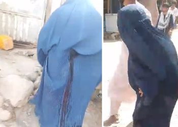 A woman in a blue burqa walks through the Yaftal-e Sufla market after being wounded during a Taliban crackdown on protesters. (Photo credit: Social Media)