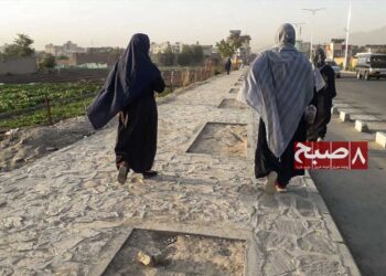 Two women walk along a stone path on the outskirts of Kabul after gyms were closed to them under Taliban restrictions. (Photo credit: 8am.media)