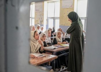 A female teacher conducts a lesson in a classroom in Afghanistan amid restrictions on women’s education. (Photo credit: Getty Images)