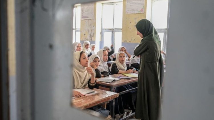 A female teacher conducts a lesson in a classroom in Afghanistan amid restrictions on women’s education. (Photo credit: Getty Images)