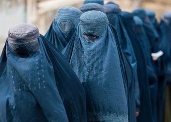 Women wearing burqas walk through a street in Afghanistan amid ongoing restrictions on women’s rights. (Photo credit: Pexels)
