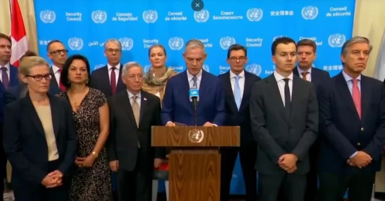 Diplomats stand together during a United Nations meeting as 43 countries call for the removal of restrictions on women and girls. (Photo credit: @franceonu)