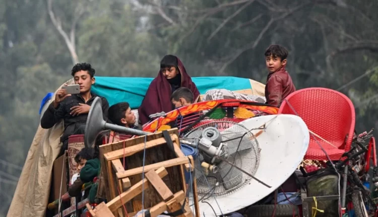 Afghan migrants traveling with their belongings after being deported (Photo: AFP)