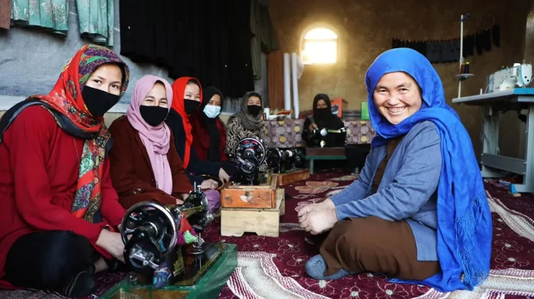 Women work on sewing machines at a community workshop in Afghanistan as part of efforts to strengthen livelihoods. (Photo credit: UN)