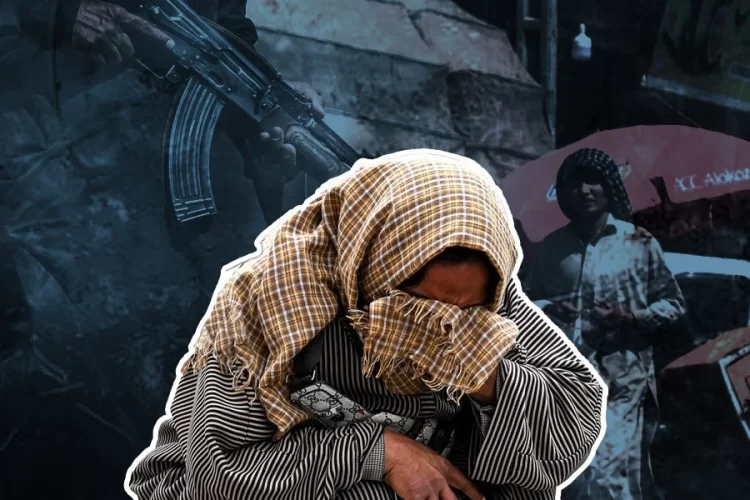 A distressed citizen covers their face with a scarf as an armed man stands in the background amid rising insecurity and poverty in Afghanistan. (Photo credit: AFP)