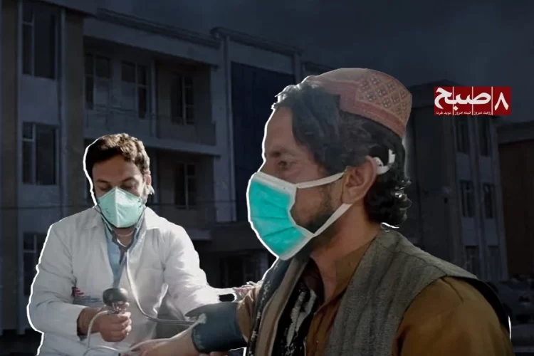 A doctor examines a patient as a Taliban official looks on outside a hospital in Zabul, amid mounting health worker concerns over mandatory turbans and mullah oversight. (Photo credit: 8am.media + Social Media)