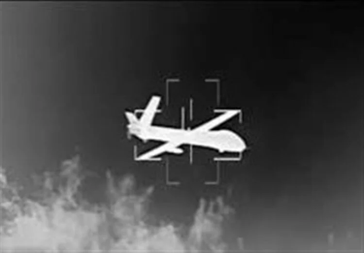 A monochrome image shows a drone flying above a cloudy landscape, viewed through a tracking system (Photo: Tasnim)