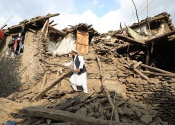 A man stands amid the ruins of a home destroyed by an earthquake in eastern Afghanistan. (Photo credit: WFP)