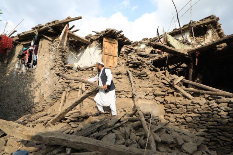 A man stands amid the ruins of a home destroyed by an earthquake in eastern Afghanistan. (Photo credit: WFP)