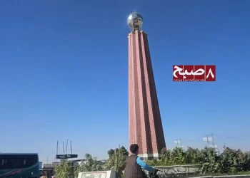 A tall brick tower topped with a metallic globe stands at a city roundabout as a land dispute escalates in Ghazni province. (Photo credit: 8am.media)