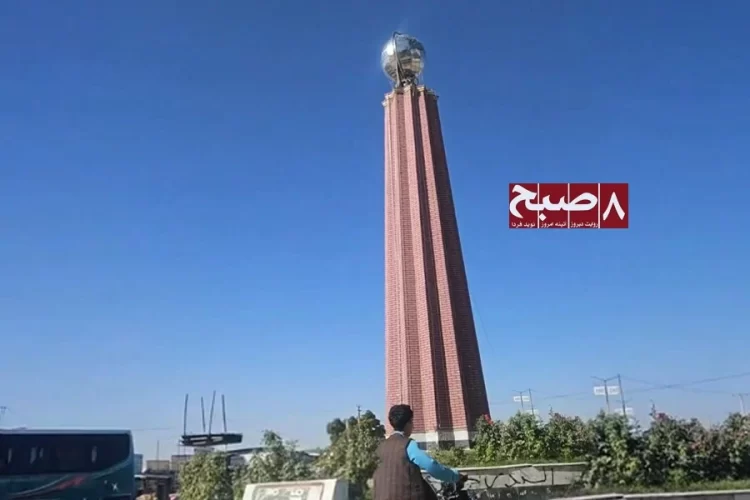 A tall brick tower topped with a metallic globe stands at a city roundabout as a land dispute escalates in Ghazni province. (Photo credit: 8am.media)
