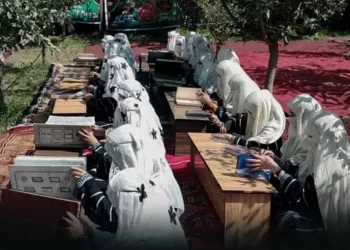 Girls sit at outdoor desks studying religious texts in Afghanistan amid the expansion of Taliban-run religious schools. (Photo credit: BakhtarNews)
