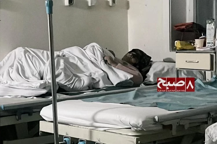 A patient rests on a bed at a government hospital in Kabul, as citizens complain that treatment costs now differ little from private clinics. (Photo credit: 8am.media)