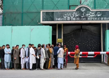 Crowds of visa applicants wait outside the Embassy of the Islamic Republic of Iran, as restrictions fuel a black market visa trade. (Photo credit: Getty Images)