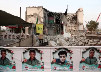 A devastated school and its students in Iran following a US airstrike. (Photo credit: Reuters)